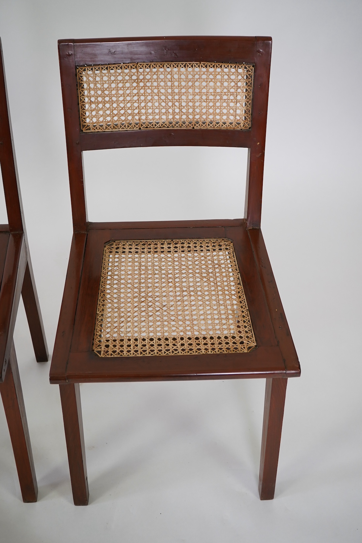 Pierre Jeanneret (Swiss, 1896-1967) for Chandigarh: A set of four solid solid teak and braided canework chairs PJ-010501